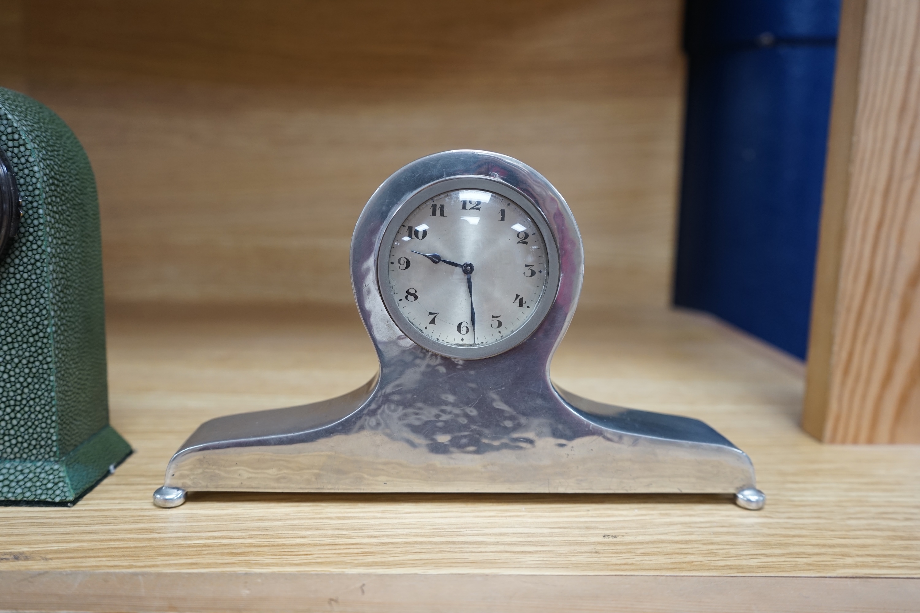 Three small mantel timepieces including a Tudric pewter timepiece, and a French timepiece in an alabaster case, signed Henry Marc, Paris. Condition - fair to good.